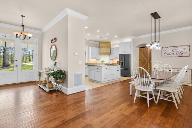 270 Milford Trl, Talking Rock, GA 30175 - dining area featuring a chandelier, crown molding, visible vents, and light wood-style flooring