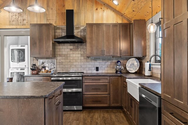 1667 S Old Federal Rd, Chatsworth, GA 30705 - kitchen with stacked washer / drying machine, stainless steel appliances, wall chimney exhaust hood, dark countertops, and vaulted ceiling