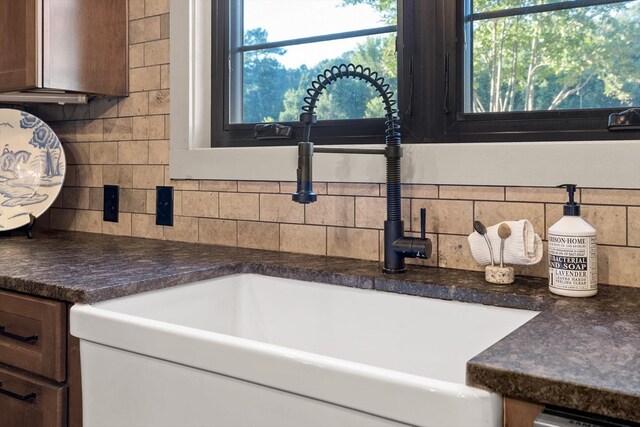 1667 S Old Federal Rd, Chatsworth, GA 30705 - kitchen view of a sink, decorative backsplash, dark countertops, and dishwashing machine
