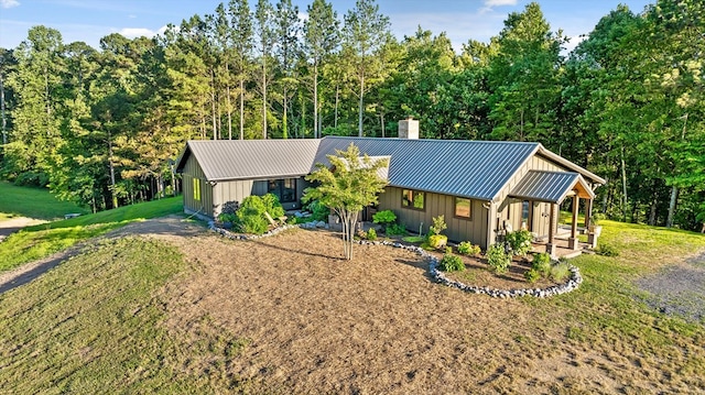 1667 S Old Federal Rd, Chatsworth, GA 30705 - view of front of home with board and batten siding, a chimney, metal roof, and a front lawn