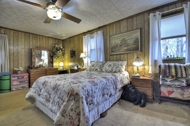 bedroom with wooden walls, ornamental molding, and carpet flooring