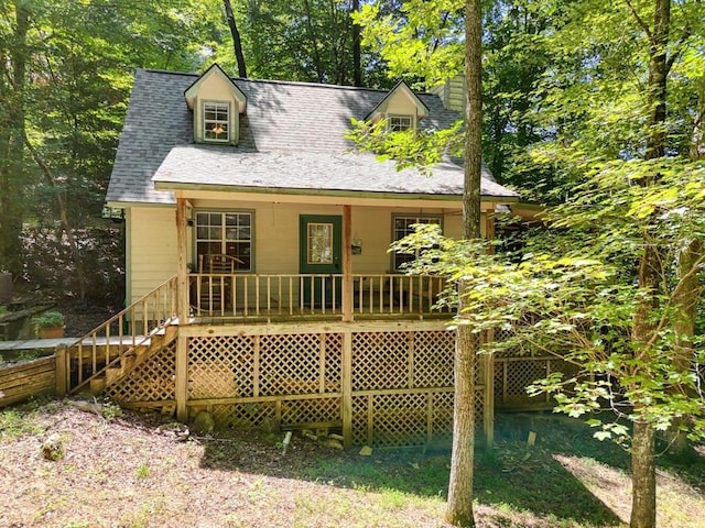 back of house with stairway and a porch