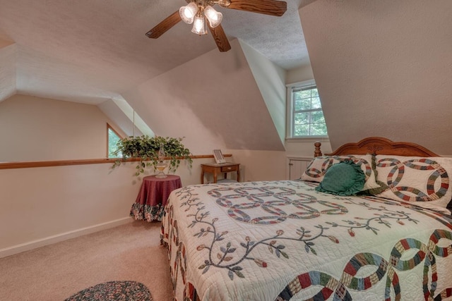 carpeted bedroom featuring a textured ceiling, ceiling fan, and lofted ceiling