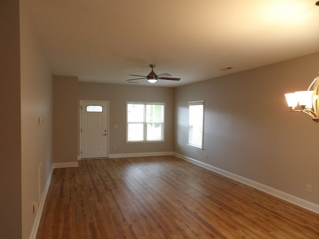 entrance foyer featuring wood-type flooring and ceiling fan with notable chandelier