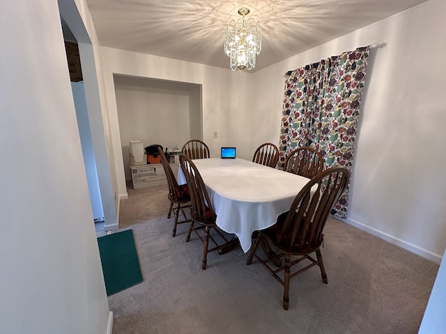 carpeted dining area featuring a notable chandelier