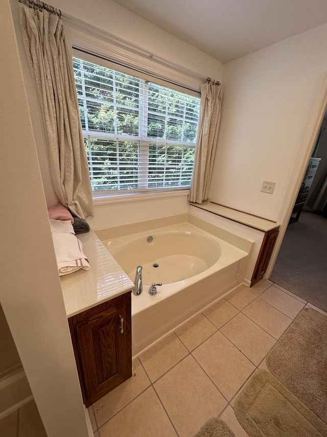 bathroom featuring a tub to relax in and tile patterned floors