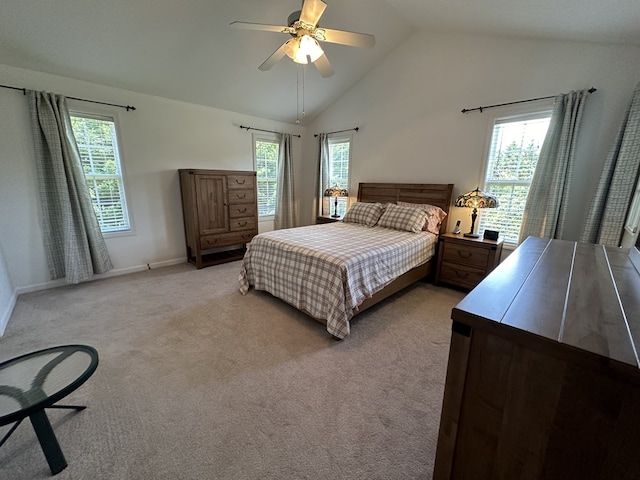 carpeted bedroom with multiple windows, ceiling fan, and lofted ceiling