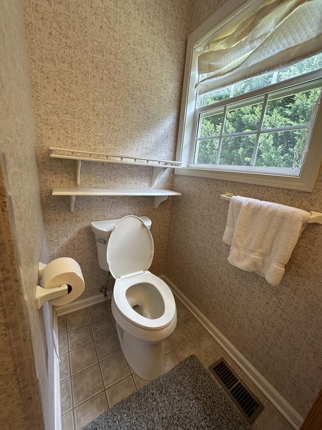 bathroom featuring toilet and tile patterned flooring