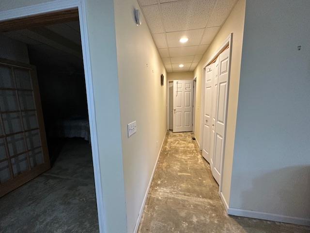 corridor featuring a paneled ceiling