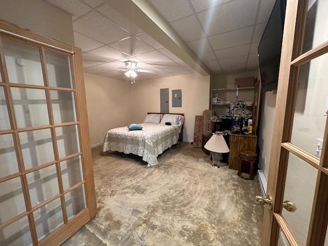 bedroom with french doors, ceiling fan, a drop ceiling, and electric panel