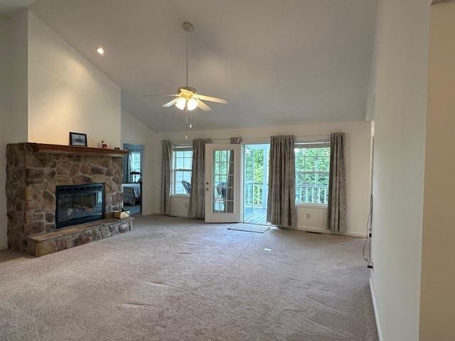 unfurnished living room featuring a stone fireplace, carpet flooring, high vaulted ceiling, and ceiling fan