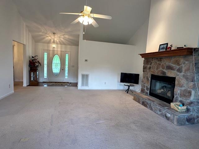 unfurnished living room with a stone fireplace, carpet, high vaulted ceiling, and ceiling fan