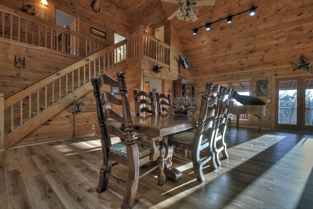 dining room with dark wood-type flooring, high vaulted ceiling, and french doors