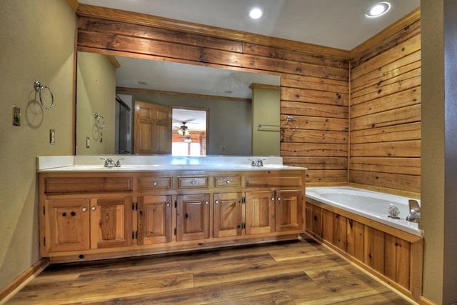 bathroom with vanity, hardwood / wood-style flooring, and a tub