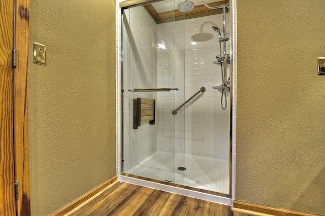 bathroom featuring hardwood / wood-style floors and an enclosed shower