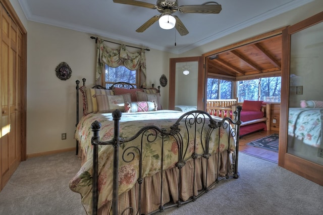 carpeted bedroom featuring a closet, wood ceiling, multiple windows, and ceiling fan