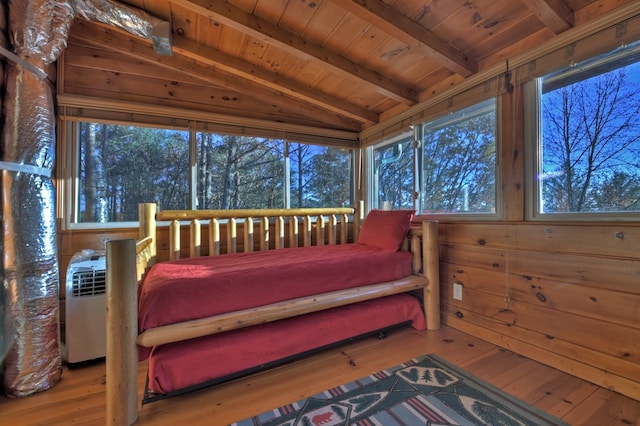 sunroom / solarium featuring lofted ceiling with beams and wood ceiling