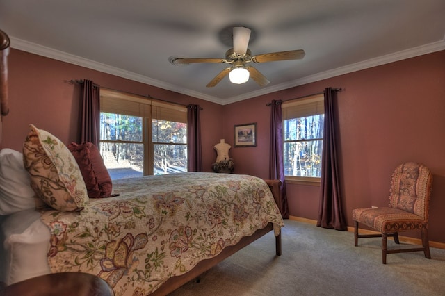 carpeted bedroom featuring ceiling fan and crown molding