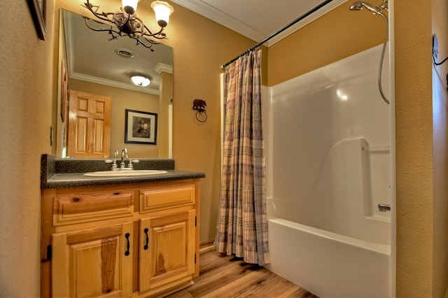 bathroom featuring vanity, crown molding, an inviting chandelier, shower / bathtub combination with curtain, and hardwood / wood-style floors