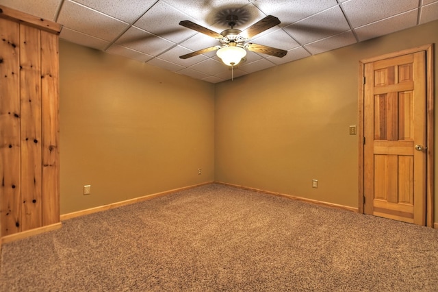 unfurnished room featuring carpet floors, a drop ceiling, and ceiling fan