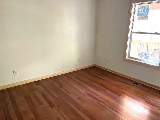 unfurnished room featuring hardwood / wood-style floors