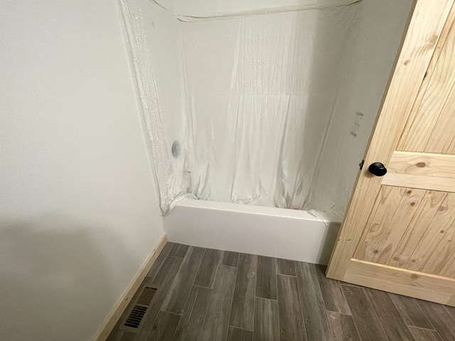 bathroom with hardwood / wood-style flooring