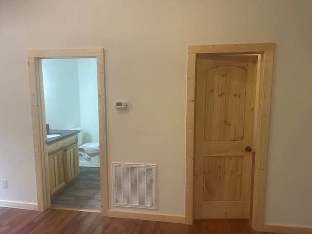 hall with dark wood-type flooring and sink