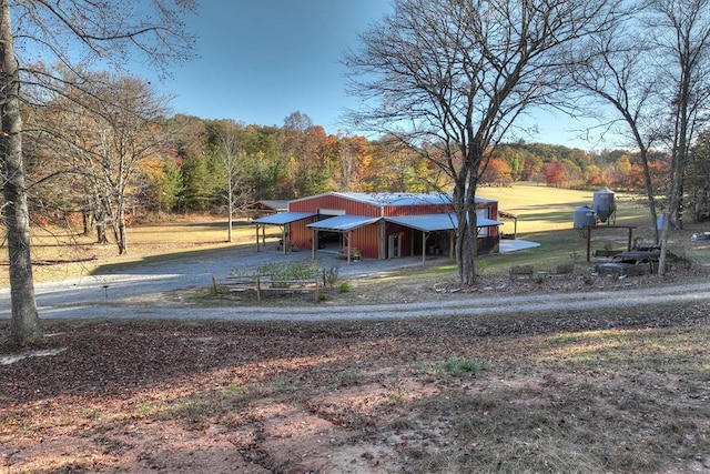 4011 Murphy Hwy, Mineral Bluff, GA 30559 - view of yard featuring dirt driveway, a pole building, a view of trees, an outbuilding, and a carport