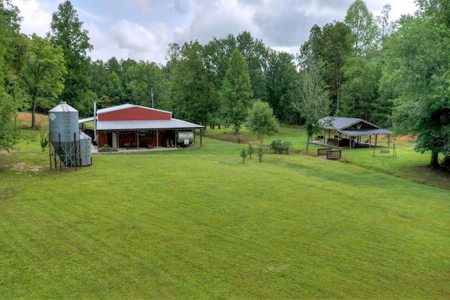 4011 Murphy Hwy, Mineral Bluff, GA 30559 - view of green lawn with a pole building, an outdoor structure, a carport, and a forest view