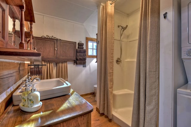 4011 Murphy Hwy, Mineral Bluff, GA 30559 - bathroom with estacked washer and dryer, a stall shower, toilet, and wood finished floors