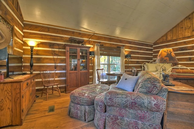 4011 Murphy Hwy, Mineral Bluff, GA 30559 - living area featuring wooden walls, hardwood / wood-style floors, and vaulted ceiling