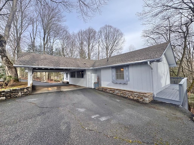 137 Pleasant Mountain Dr, Sky Valley, GA 30537 - view of front facade featuring an attached carport, driveway, a wooden deck, and roof with shingles