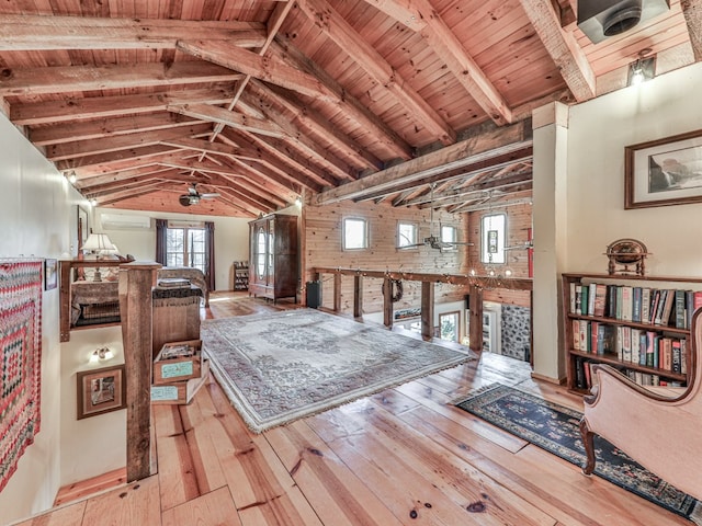 sitting room featuring a wall mounted air conditioner, light hardwood / wood-style floors, ceiling fan, and wooden ceiling