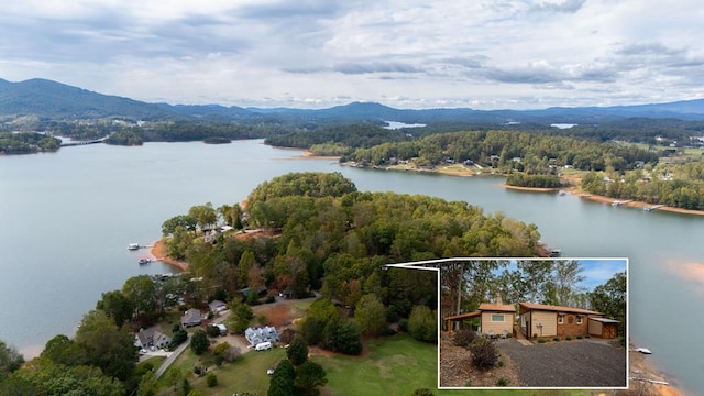 drone / aerial view featuring a water and mountain view