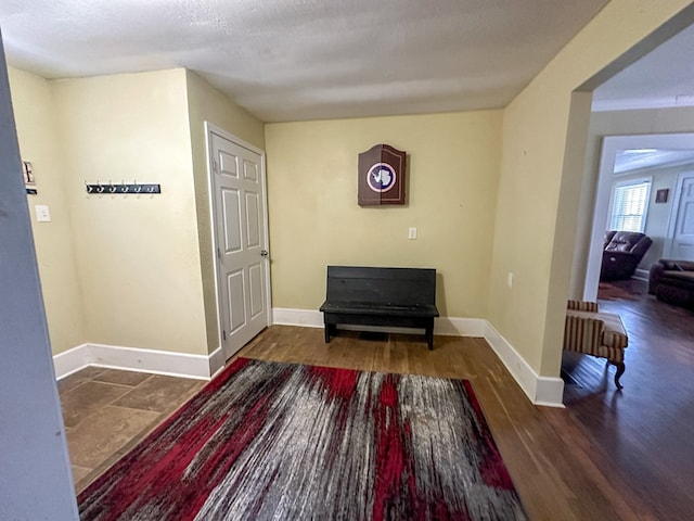 interior space featuring baseboards and wood finished floors