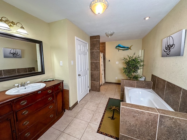 full bath featuring baseboards, tile patterned flooring, a tile shower, vanity, and a bath