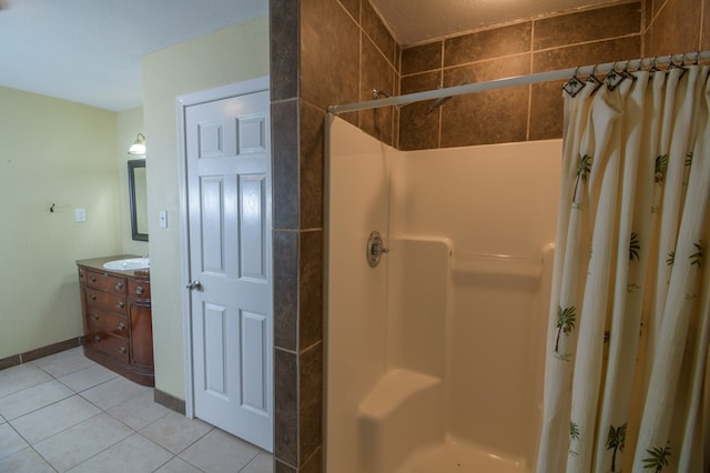 bathroom with a stall shower, tile patterned flooring, and vanity