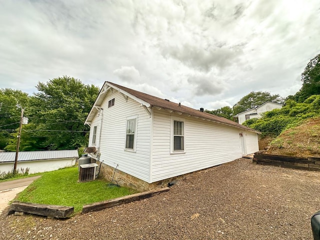 view of side of property featuring central AC unit