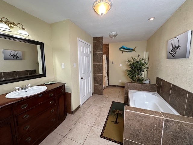 bathroom featuring baseboards, a garden tub, tile patterned flooring, walk in shower, and vanity