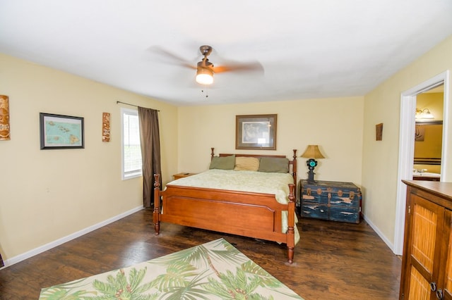 bedroom with dark wood-style flooring, ceiling fan, and baseboards