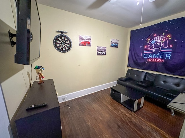 home theater with ceiling fan, baseboards, and wood finished floors