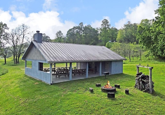 surrounding community featuring a patio area, a lawn, a fire pit, and a gazebo