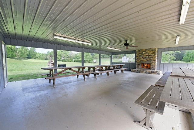 view of patio / terrace with ceiling fan and a stone fireplace