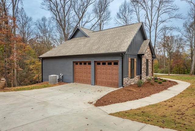 view of side of property with a garage and central AC unit