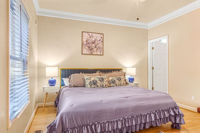 bedroom featuring light hardwood / wood-style flooring and ornamental molding