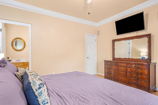 bedroom with ensuite bathroom, sink, hardwood / wood-style floors, and crown molding