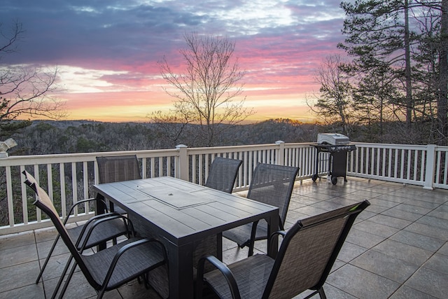 patio terrace at dusk with a grill