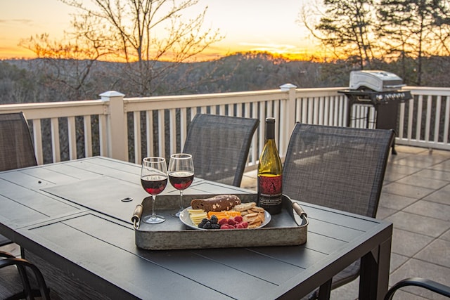 deck at dusk with area for grilling