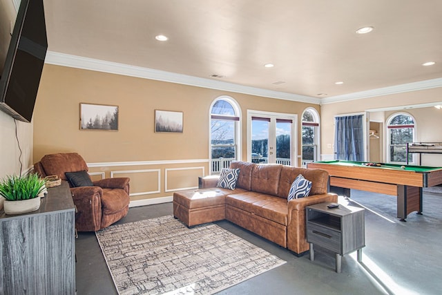 living room featuring plenty of natural light, ornamental molding, and french doors