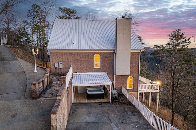 back house at dusk with a balcony